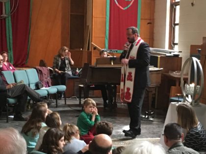 Rev. Zsolt speaking to children