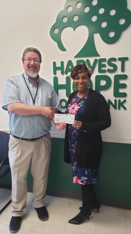 Scott Sargent gives check to Harvest Hope